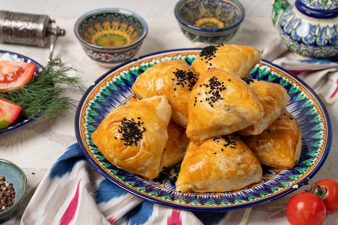 Golden crispy samsa pastry pockets fresh from the tandoor